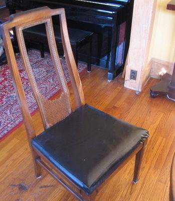 Our crappy chairs, pre-fix-up. Notice the hideous black vinyl covering on the cushions.