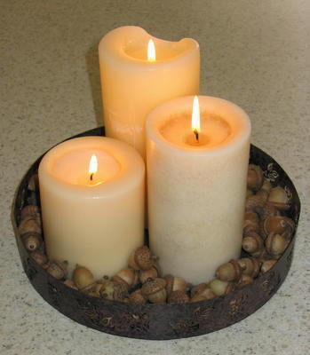 "Three Candles lighted and placed on a plate"