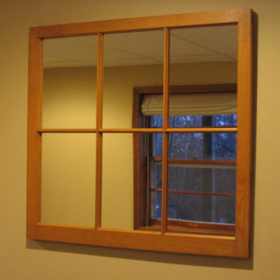 A framed window looks out at another window.