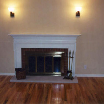 Fireplace is inside of the house on wooden floor.