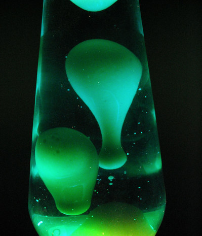 Green blobs come up in a lava lamp.