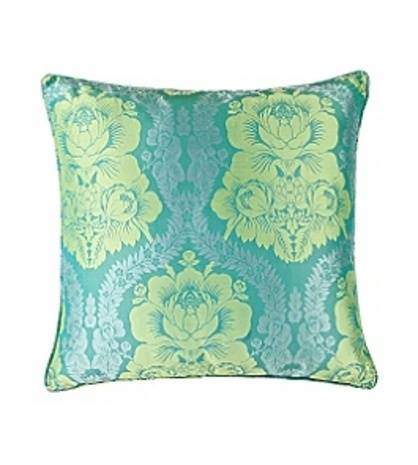 A small pillow in dark and light fluorescent green floral patterning.