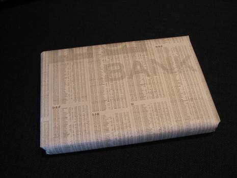 A book covering with stock reports on it.