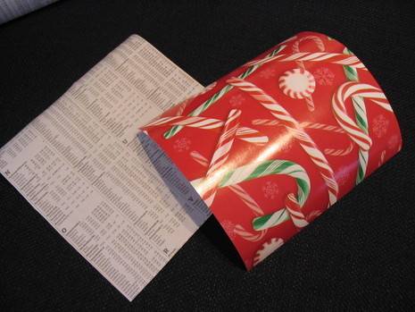 A piece of candy cane present wrapping next to a large list of text.