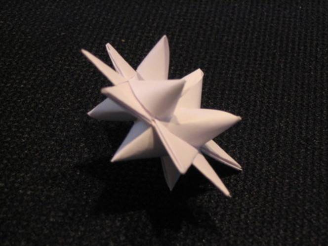 Paper star with multiple points on top of flat surface.