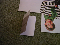 A person in a striped shirt is modeling on a paper.
