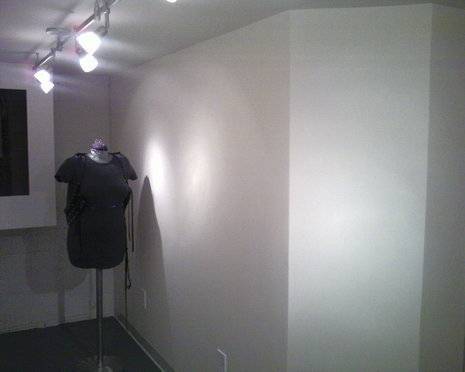 A shirt on a headless mannequin in a room