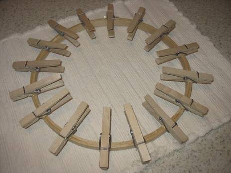 Clothes pins are used to make a circular craft.