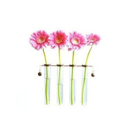 Pink daisies lined up and pinned to a metal rod.