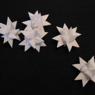Five white folded paper stars.