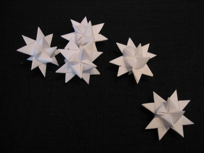 Five white folded paper stars.