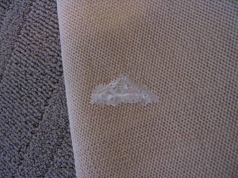 A white repair on the under of a rug.