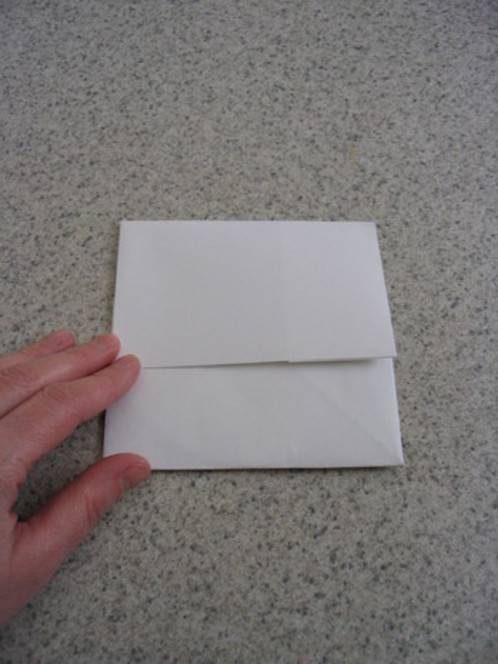 A person is touching a small piece of paper.