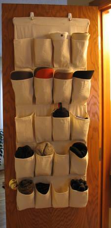 White cloth shoe organizer hung on the door.