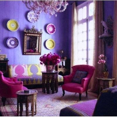 Chairs and furnishings fill a purple room with lots of wall decorations.