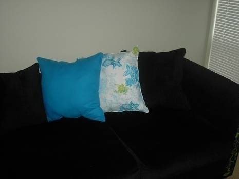 "Blue and white colored small Cushions on the Sofa"