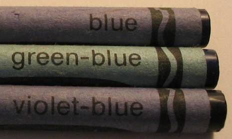 Different shades of blue crayons are arranged.
