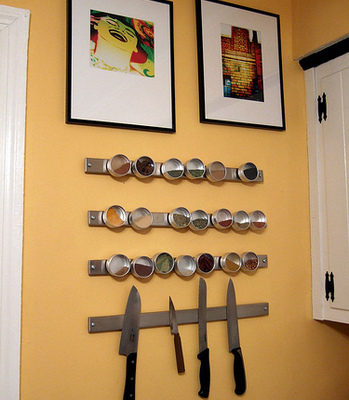A wall with knives and art works