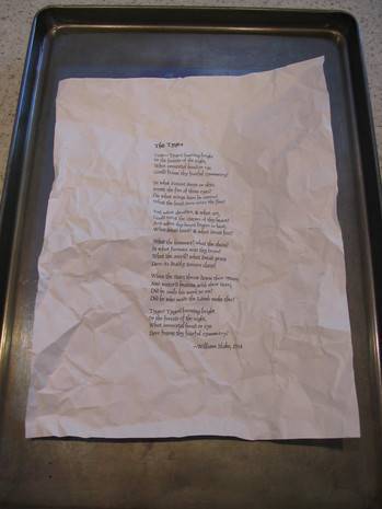 Words are printed on a crumpled white sheet of paper.