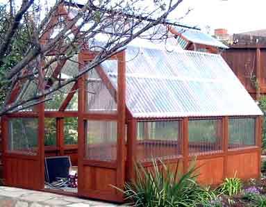 A greenhouse is made out of wood and glass.