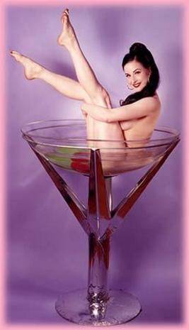 A nude woman is bathing on the champagne glass.