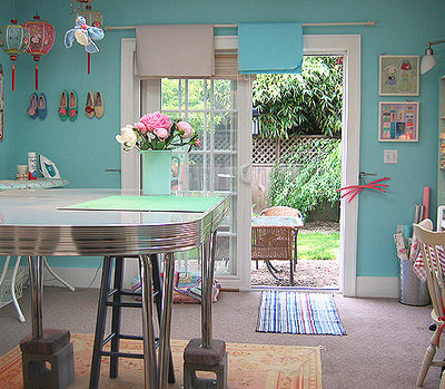 A table is set up in a blue room with a lot of wall decorations.