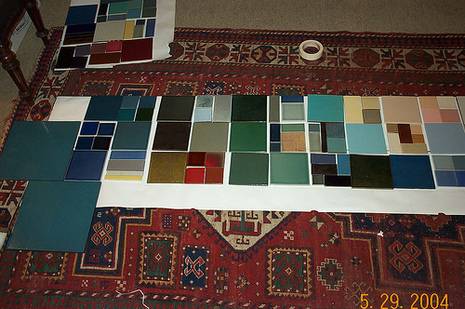 Random square fabric patterns laid out on a throw rug.