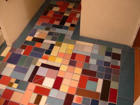 A tile floor made up of many different colored tiles.