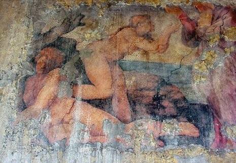 An old decaying painting of two naked women.