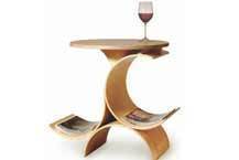 A glass of red wine sits on a uniquely shaped wooden table.