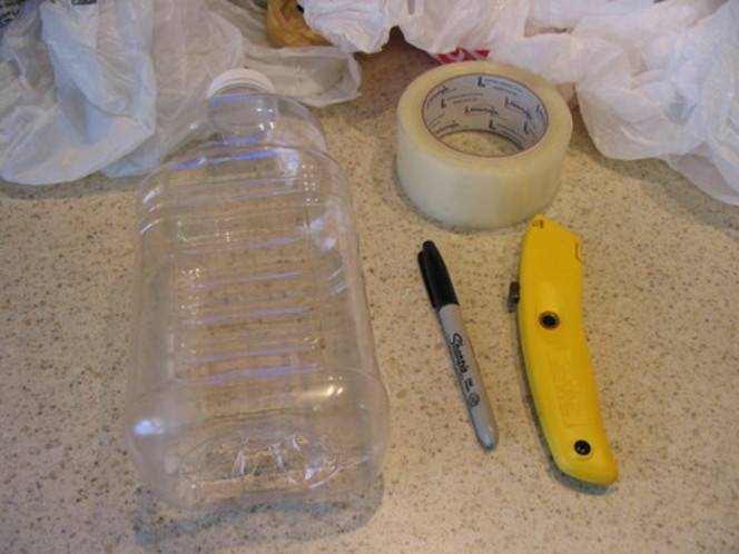 A plastic bottle, a roll of tape, a Sharpie marker, and a box cutter laid out together on a hard surface.
