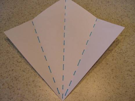 A pink paper is in a diamond shape with blue dotted lines.