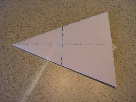 Paper is folded like triangle to prepare origami craft.