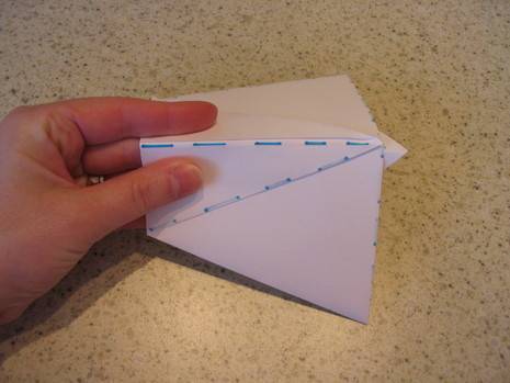 "Folding a white Paper to do an Origami"