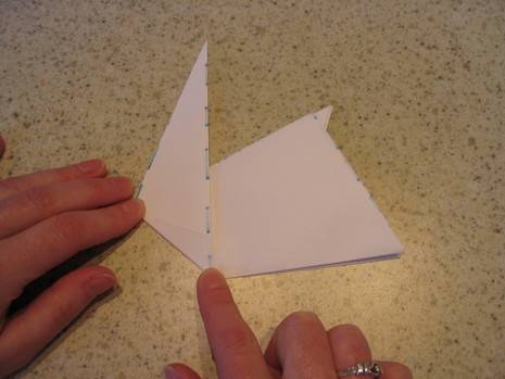 "A person is trying Origami with a paper"