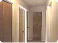 Hallway with many wooden slab doors.