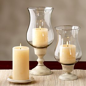 Candles are in the glass parts of vases.