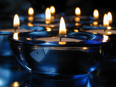Several tealight candles light the darkness.
