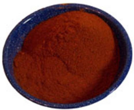 A blue bowl full of a ground up red substance.