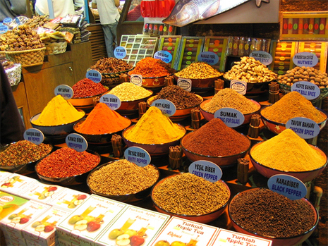 Bins of colorful spices displayed at a spice market.