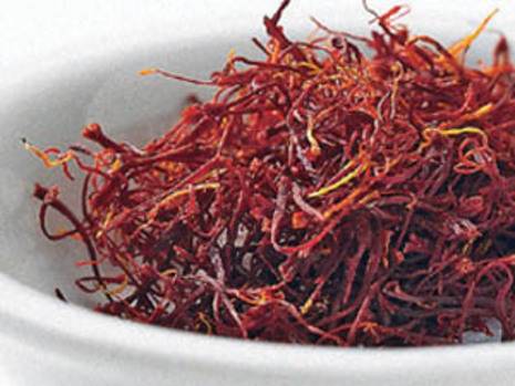 A bowl holding a large bunch of saffron threads.