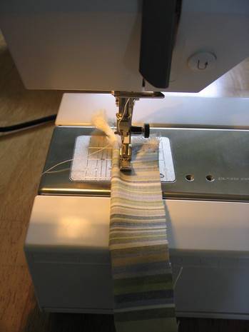 Fabric piece is placed in a sewing machine.