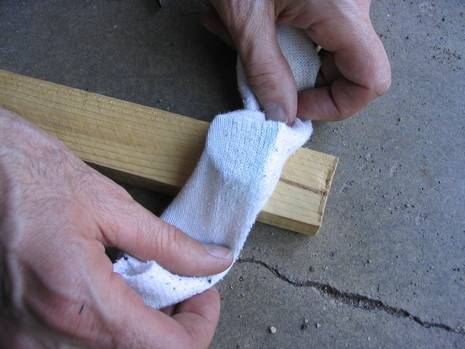 Wrap soap in a sock and attach to a wooden stake