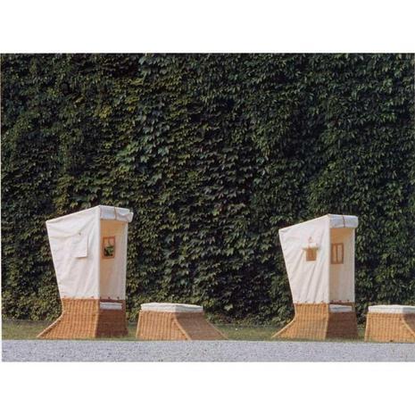 Two windproof boxes are on the side of the bushes.