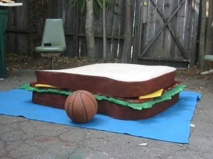 Sandwich costume with basketball aside is on the mat.