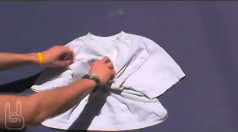 Woman folding white fabric with hands.