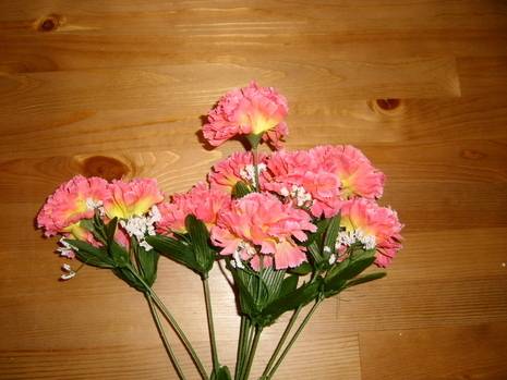 Bunch of pink color plastic flowers with leaves and stems.