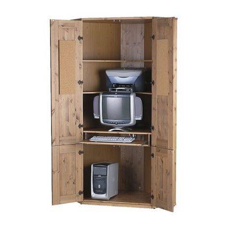 A desktop computer sits on wooden shelving.