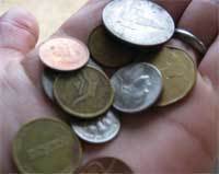 Person holding handful of coins.