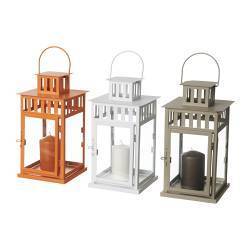 Three lanterns with candles next to each in copper, white, and silver finishes.